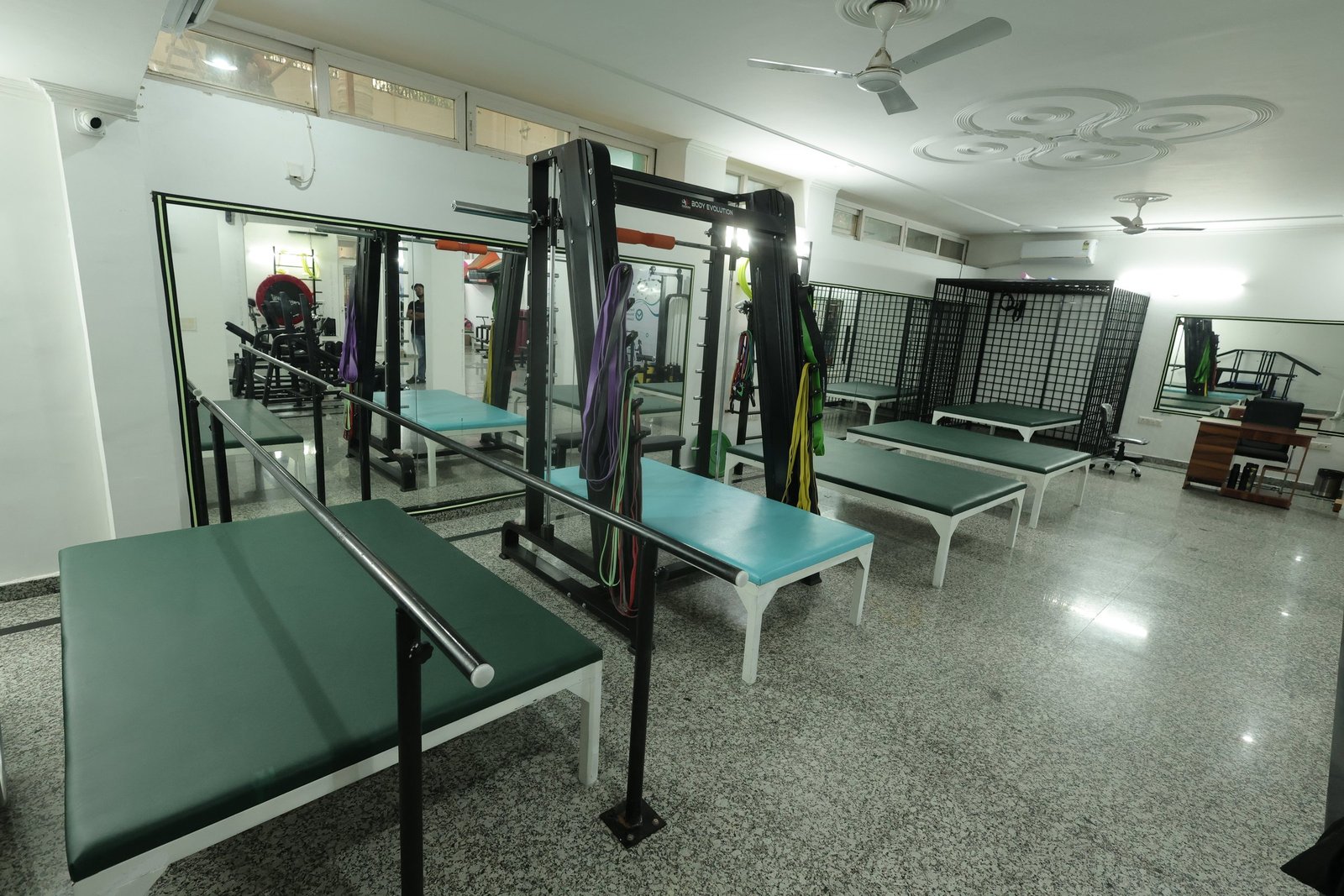 Gait training area at Neuranta rehabilitation centre, Sector 39 Gurugram, with parallel bars, treatment plinths and resistance bands